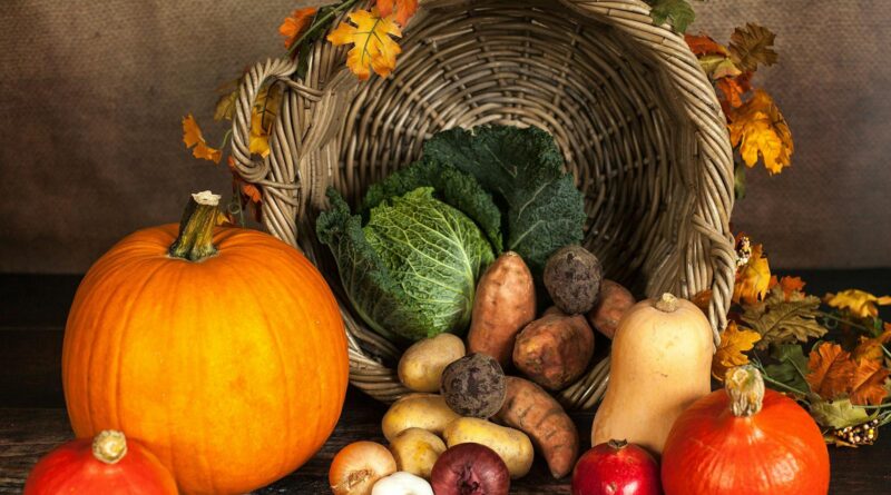 A rustic cornucopia overflowing with fresh autumn vegetables, symbolizing abundance and harvest.